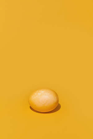 A painted Easter egg on a yellow background. With space to copy. High quality photo