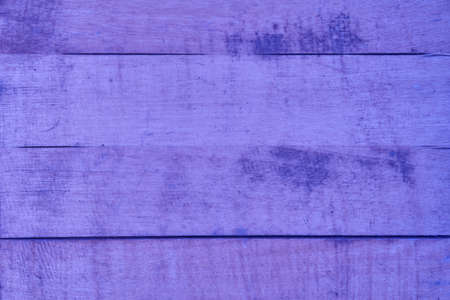 The texture of the wooden surface is purple very peri colour with horizontal lines. Texture and background. High quality photoの写真素材