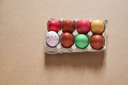 Top view of Easter multicolored eggs in cells. Minimal concept.With a space to copy. High quality...