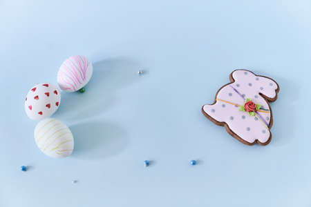 Close-up of three Easter eggs with a pattern of hearts and lines on a blue background and a...