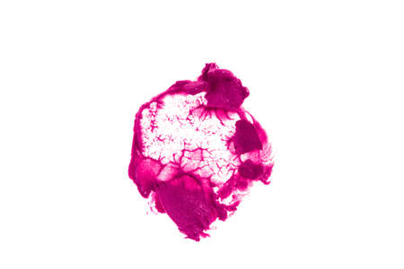 Close-up of the creamy texture of makeup.The crimson color of the cosmetic product. A lipstick stain stands out against a white isolated background. High quality photoの写真素材