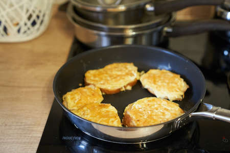 Delicious fried bread with an egg in a frying pan. Hot homemade sandwich step-by-step preparation. High quality photoの写真素材