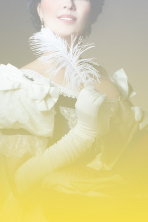 Gradient from gray to yellow. A lady with a smile in a historical costume with a feather in her hand and a letter. Design for the cover of the book. High quality photoの写真素材