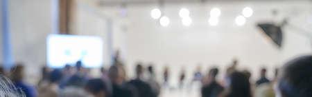 Blurred background of the business conference, a group of people on the stage, presentation of the project, public talk. High quality banner with copy spaceの写真素材