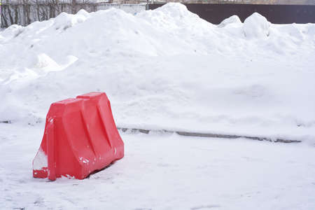 A plastic block on a background of white snow. Traffic difficulties due to the large amount of snow....