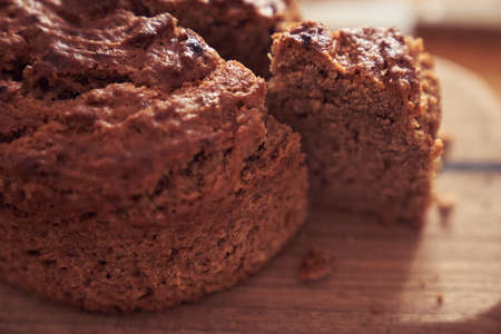 A close-up of a pie where a piece is cut off from the whole part. Diet dessert - Banana cake without...