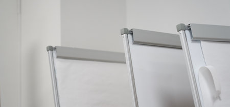 A banner from a row of clean white boards for a business presentation at the stand. Office...
