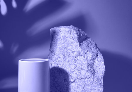 The podium is a platform for the presentation of the product, made of two objects In the background the shadow of tropical leaves. On the background of the color of the year 2022. High quality photoの写真素材