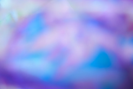 Unfocused holographic colors of mother-of-pearl foil. Blurry holographic abstract background in blue...