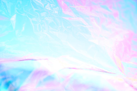 Holographic colorful plastic film in blue and pink tones. Transparent holographic wrinkled mother-of-pearl polyethylene. High quality photoの写真素材