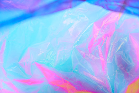 Holographic colorful plastic film in blue tones. Transparent holographic wrinkled mother-of-pearl polyethylene. High quality photoの写真素材