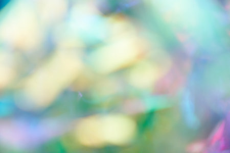 Unfocused holographic colors of mother-of-pearl foil. Blurry holographic abstract background in blue tones. Holographic iridescent abstract background made of rainbow foil. High quality photoの写真素材