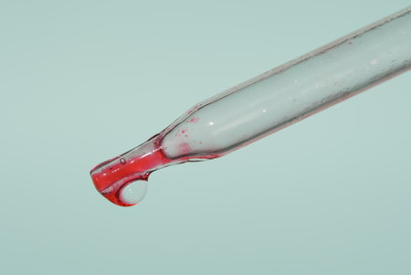 The last drop in the pipette of blood. The concept of developing a pharmaceutical drug for the treatment of diseases with the help of drugs that improve DNA. High quality photoの写真素材