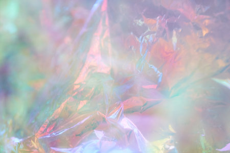 Iridescent texture. Holographic background. A hologram of gradient neon color. Foil effect. Rainbow graphics. Chrome-plated space design for prints. High quality photoの写真素材