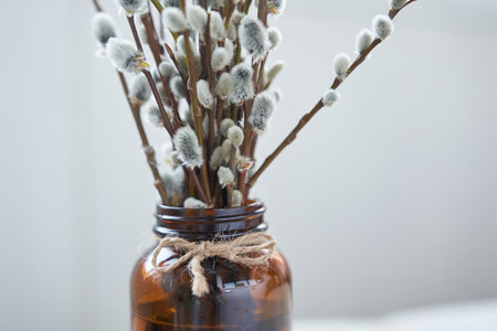 Part of a willow bouquet with a brown glass vase. Happy Easter concept with copy space. High quality...