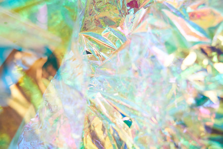 Unfocused holographic colors of mother-of-pearl foil. Crumpled iridescent foil with a real texture....