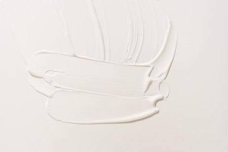 A white cosmetic smear on an isolated white background. Sample for advertising and packaging. The texture of a white face cream. Cosmetic skin care product with copy space. High quality photoの写真素材