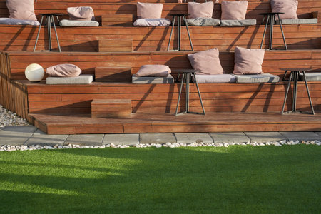 The citys upscale cafe on benches is a place for public gatherings of modern recreation. Empty wooden benches on the roof of the cafe building or outside cinema. High quality photoの写真素材