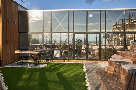 The citys upscale cafe on benches is a place for public gatherings of modern recreation. Empty wooden benches on the roof of the cafe building or outside cinema. High quality photoの写真素材