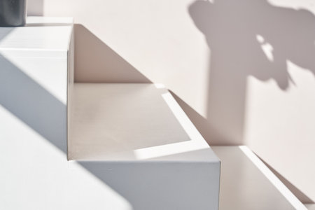 Stairs podium, stairs platform. Podium with stairs . Studio room background with sunlight and shadows for product demonstration. The shadow of geometry form. High quality photoの写真素材