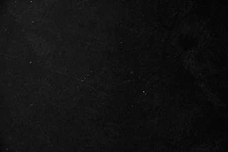 The surface of the damaged wall is black as a background coating for your design with a grunge...