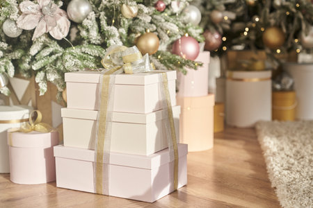 A lovely Christmas tree with beautifully packaged gift boxes under it with space to copy. High quality photoの写真素材