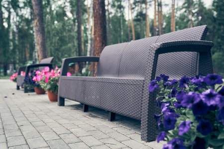 Close-up of garden furniture, plastic, wicker. A bench made of woven plastic. Lightweight portable garden furniture for a country house, terraces. High quality photoの写真素材