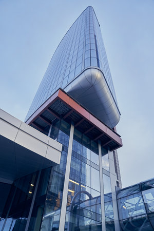Modern skyscrapers with a transparent transition between buildings in the business district against the blue sky. With a space to copy. High quality photoの写真素材