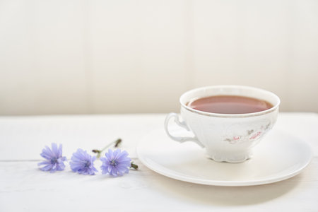 The composition of the drink from chicory, cups and saucers on a wooden table with space for copying. A healthy drink made from chicory. High quality photoの写真素材