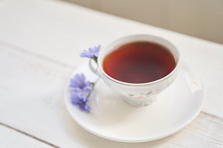 Selective focus on a drink with chicory, cups and saucers on a wooden table with space to copy. A healthy drink made from chicory. High quality photoの写真素材