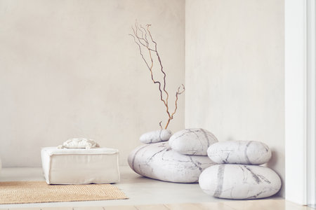 Minimal abstract light room with interior items. Decorative stones in a bright interior with space to copy on the wall background. High quality photoの写真素材