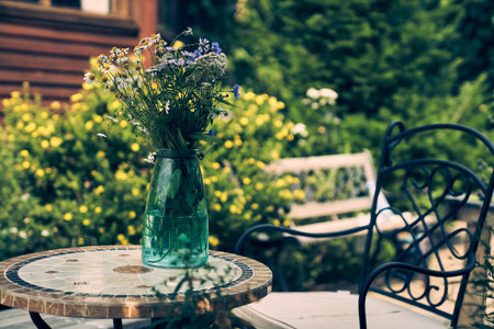 A bouquet of garden flowers was placed in a glass bottle. For decoration on the table, so that they are beautiful and moist when they are seen. High quality photoの写真素材