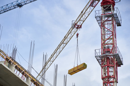 Construction of new buildings using a crane. Tower crane. Skyscrapers are being built against the blue sky. High quality photoの写真素材