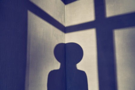 Abstract geometric light and shadow pattern on black background, in a dark room corner. Shadow from...