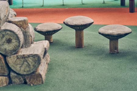 Wooden chairs that look like mushrooms. Modern eco-friendly equipment for an outdoor playground in the park. Design concept of a playground with space to copy. High quality photoの写真素材