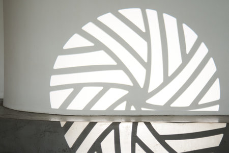 The silhouette of the gobo mask on the wall surface with space to copy. A step ledge with a shadow from a light stroke. High quality photoの写真素材