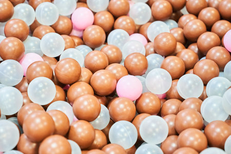 Close-up of colored plastic balls in the pool of the playroom. With space to copy. High quality...