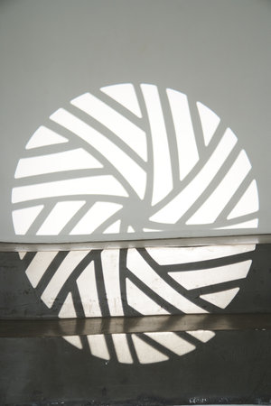 The ledge of the step with a shadow from the light pattern. The silhouette of the gobo mask on the...