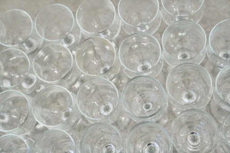 An endless array of empty, clean wine glasses lined up in close-up. High quality photoの写真素材