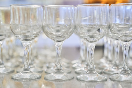 A row of empty, clear, clean wine glasses. Close-up with space to copy. High quality photoの写真素材