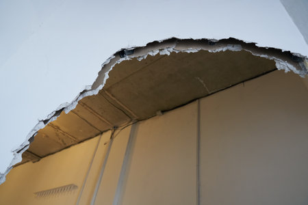 Broken drywall, a background crack with a white wall texture. With space to copy. High quality photo
