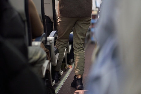 Passengers sit along the row in the plane in their seats. The concept of travel. High quality photoの写真素材