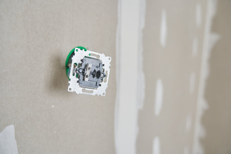 Preparing to install the outlet. Junction box with electrical wires. The background is made of...