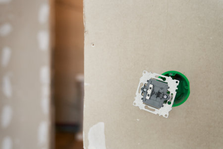An unfinished electrical outlet with electrical wires plugged into the wall in the apartment. High quality photoの写真素材