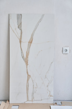 Large rectangular marble wall tiles measuring 120 by 60. On the background of a wall under daylight. High quality photoの写真素材