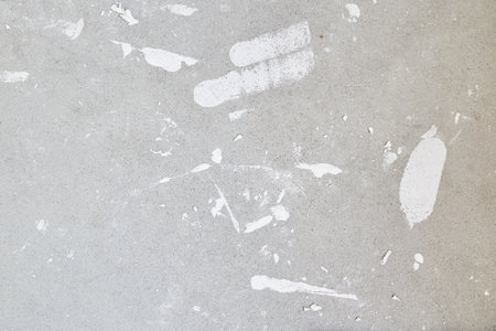 A concrete wall with putty stains. Uneven wall surface with space for copying. High quality photo