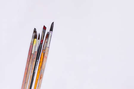 Paint brushes on a white background. Stained with paintの写真素材