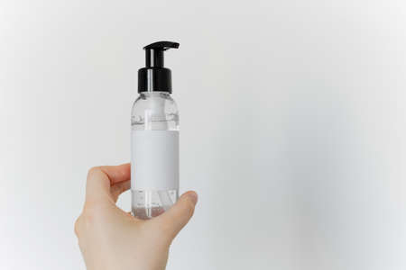 Antiseptic gel in hands on a white background