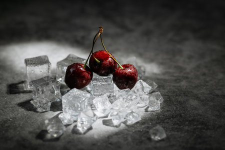 ripe cold red cherries on a dark backgroundの写真素材