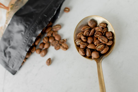 roasted coffee beans sitting displayed on a table with white bacground no peopleの写真素材